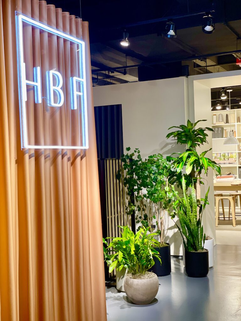 HBF's entrance decorated with a neon sign and some plants