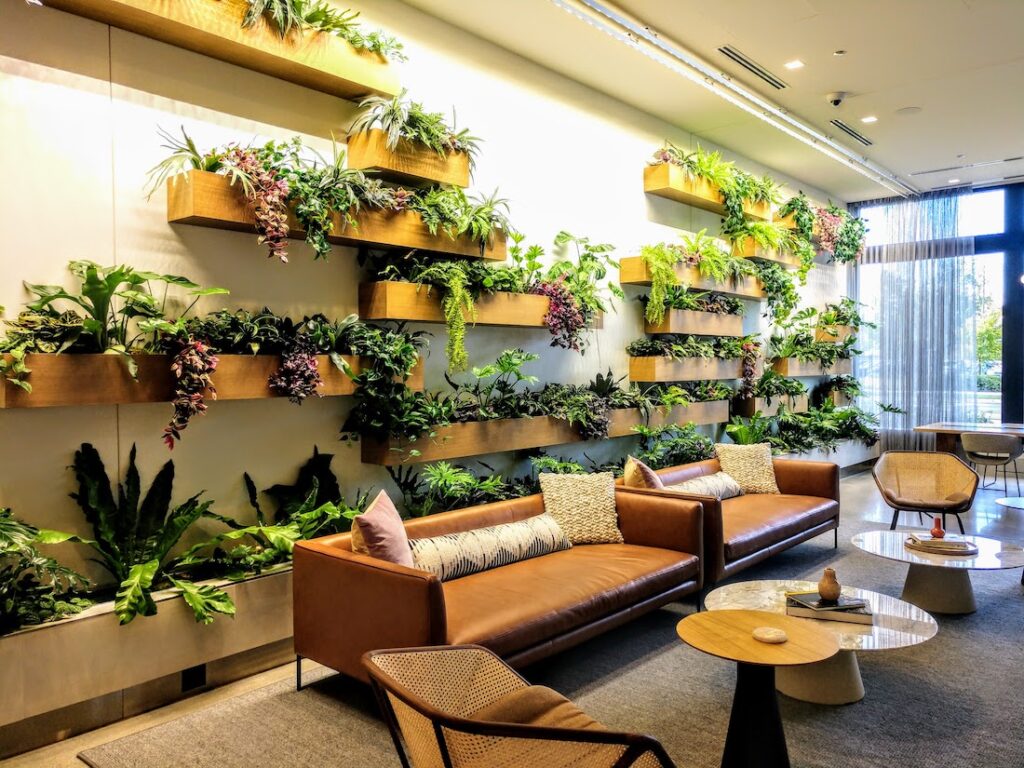 A wall with several planters in an office lobby